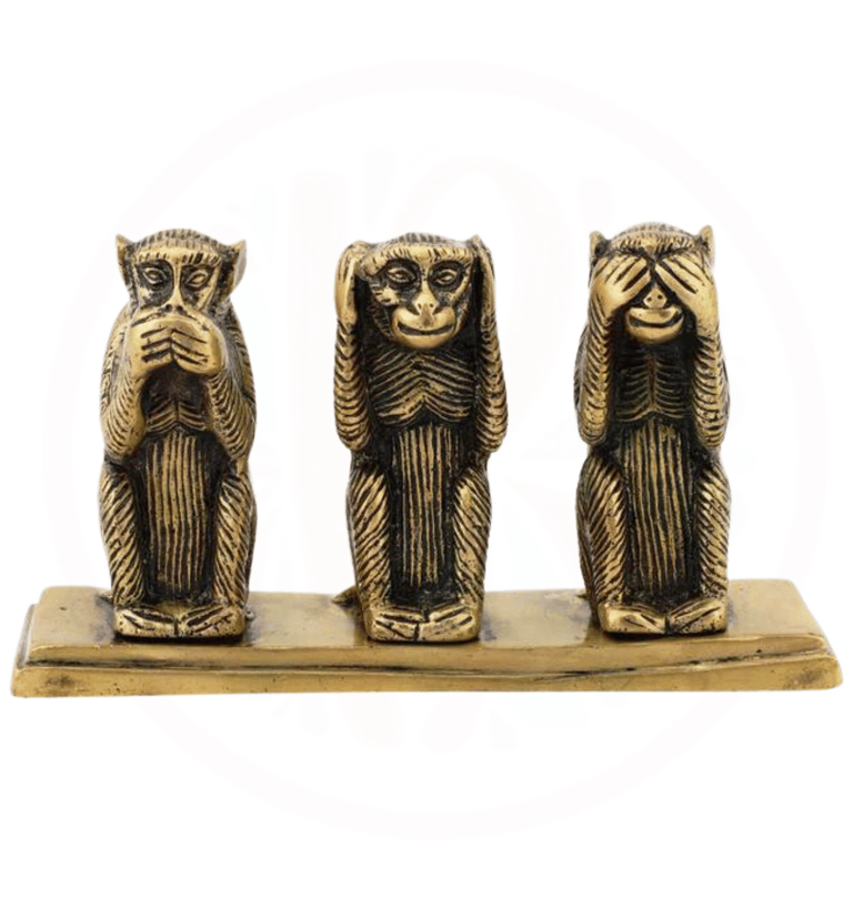 three wise monkeys sitting on a wooden block