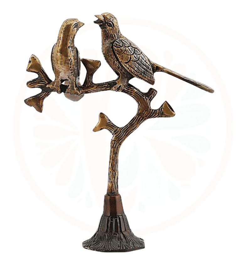 a bronze bird on a tree branch with a bird on it