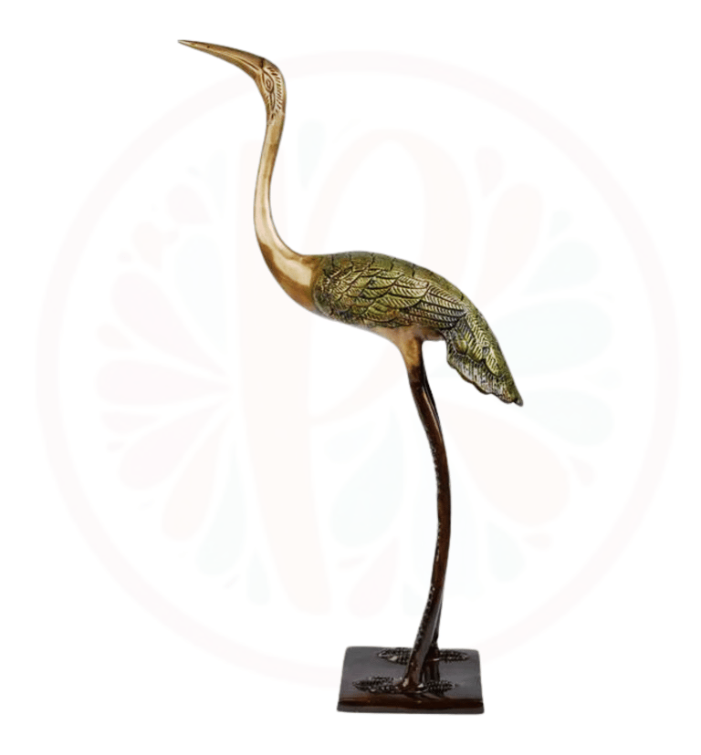 a bronze heron bird standing on a pedestal