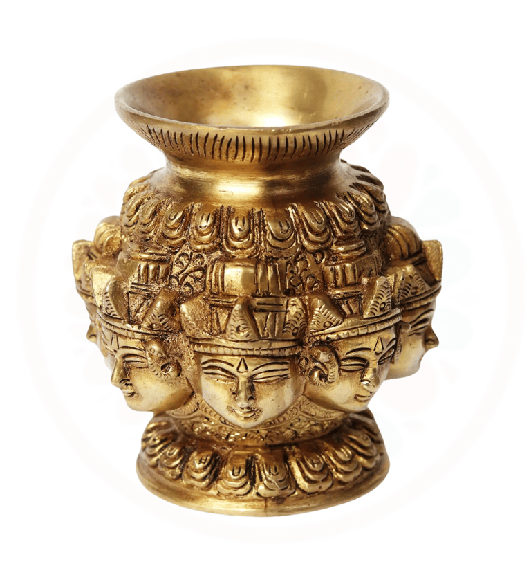 a gold vase with a face of a durga with many faces on it