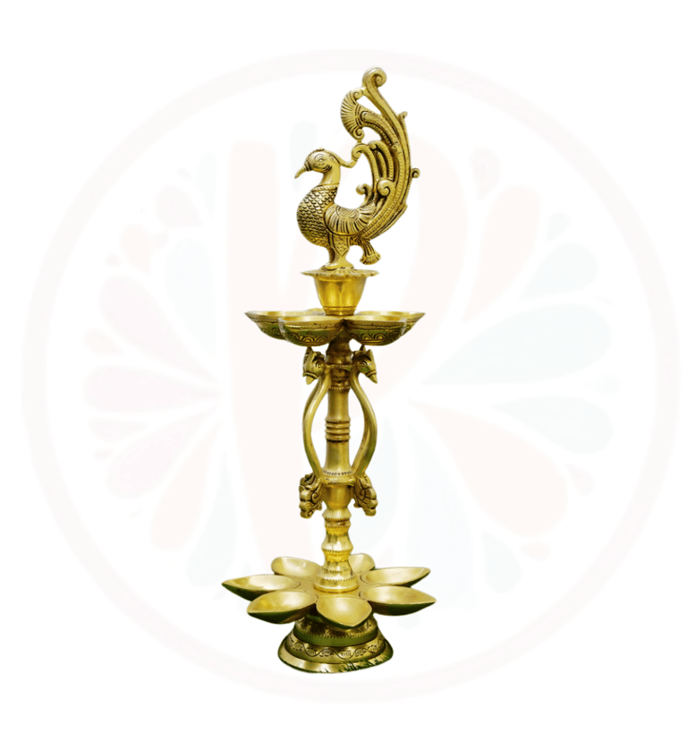 a golden colored candle holder with a peacock on it