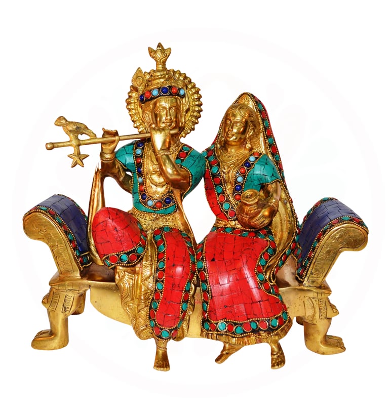 a statue of aradha krishna sitting on a bench