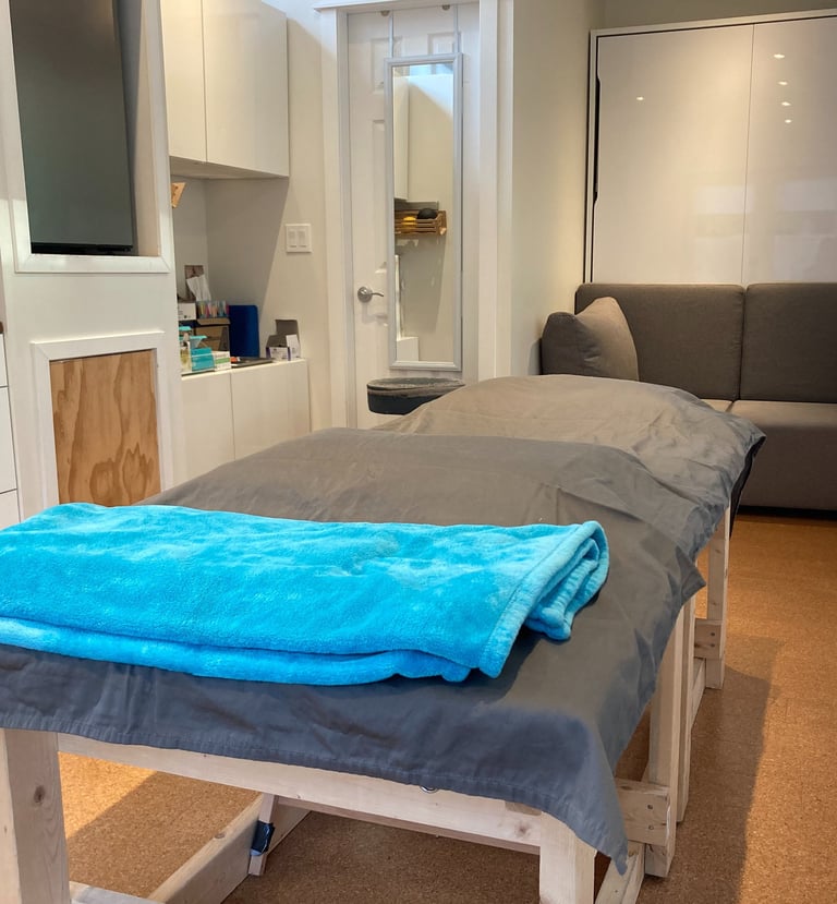 treatment table with a blue blanket