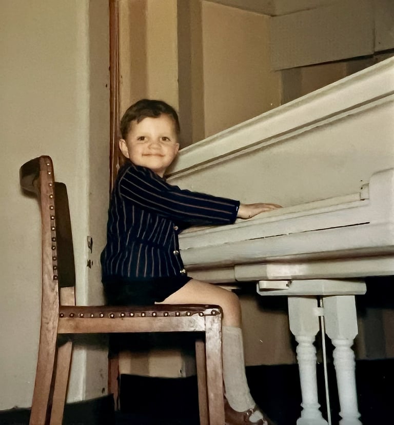 Jon Yon playing a grand piano at a very young age