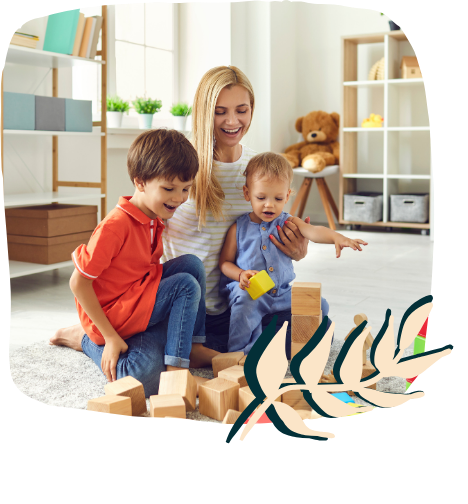 a woman and two children playing with blocks