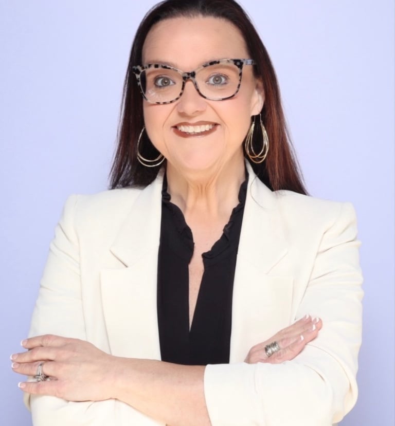 Professional headshot of Brandy Capps owner of Resiliency & Rainbows Counseling wearing a white coat