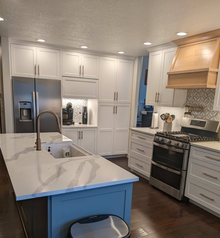 a kitchen with a farm style sink in the island