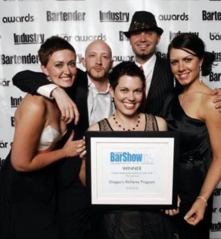 a group of people posing for a photo, they won an award