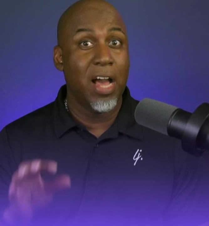 Lee Jones in a black shirt and a microphone