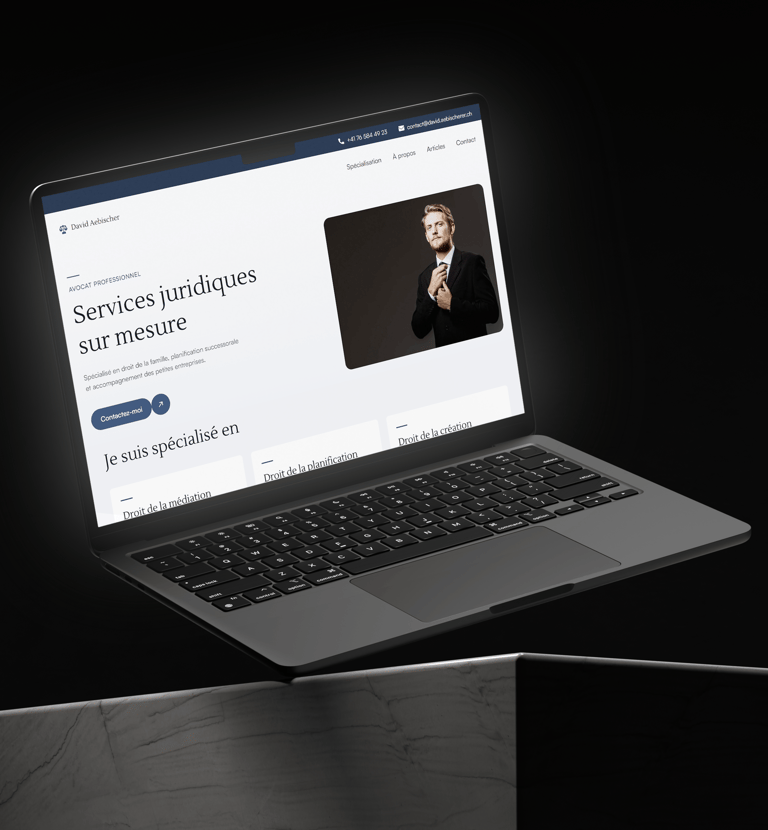 A laptop computer on a desk displaying the David Aebischer website.