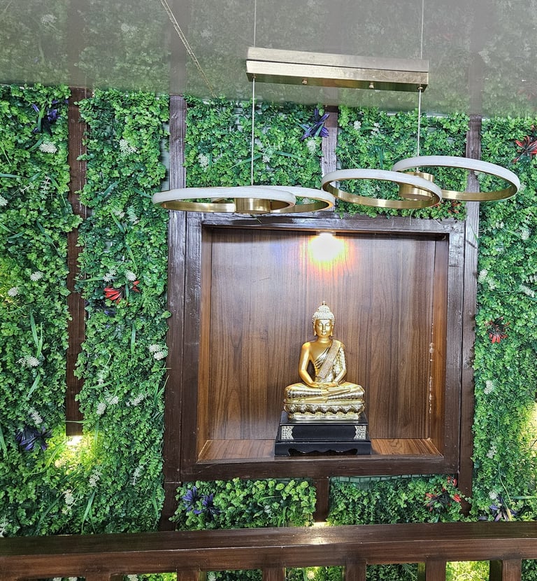 a buddha statue in a room with a green wall