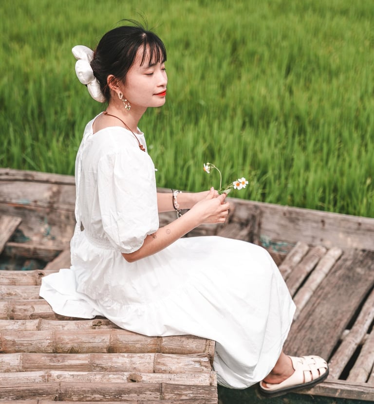 a photo of a young vietnamese woman in a rice field