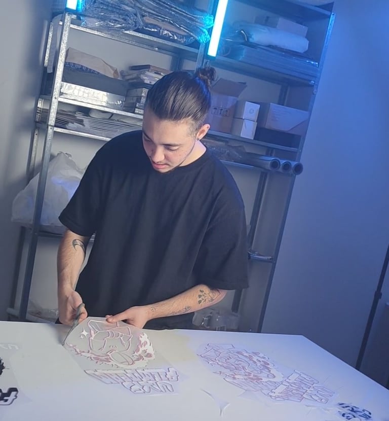a man in a black shirt is cutting paper with scissors