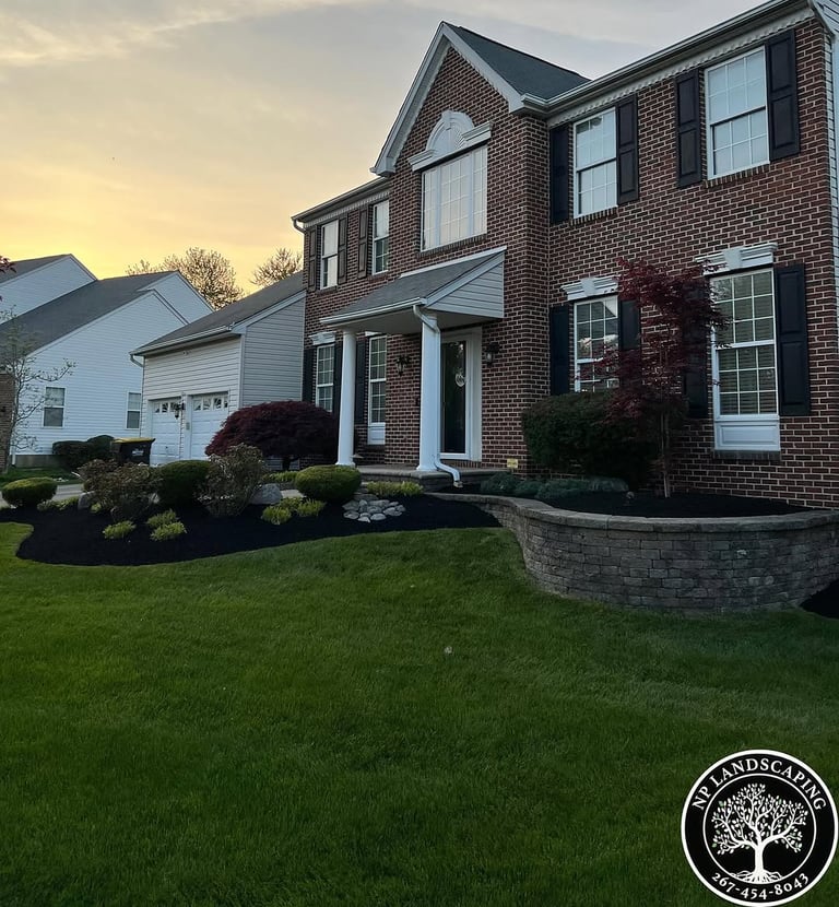 excellent landscaping and hardscaping of grass, stones and trees by NP Landscaping