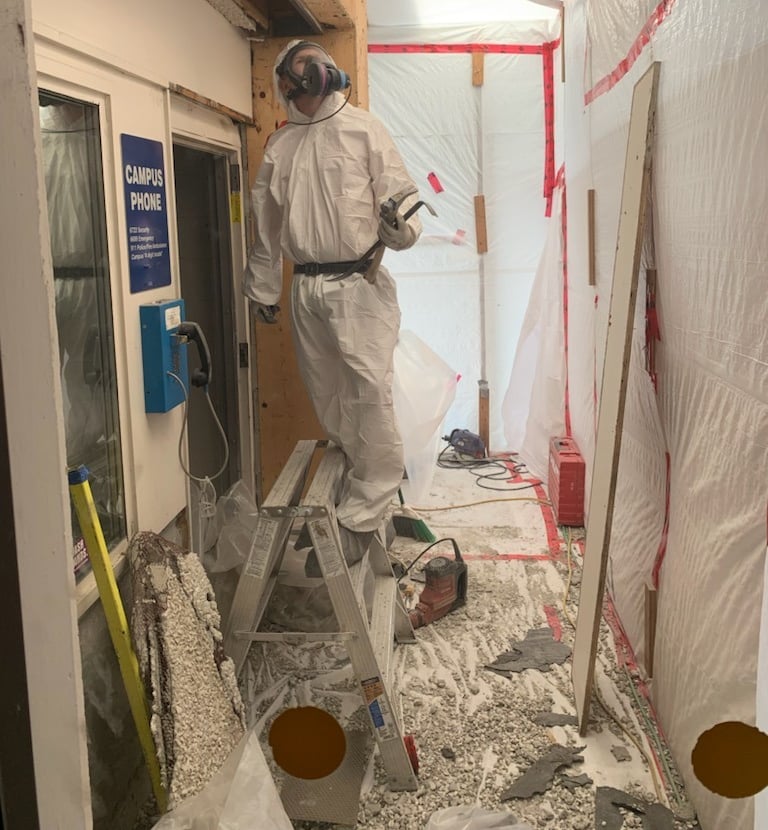 abatement worker removing asbestos
