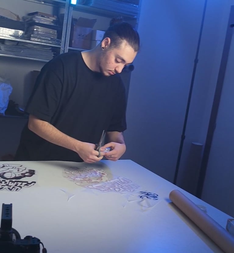 a man is cutting paper with a knife and scissors