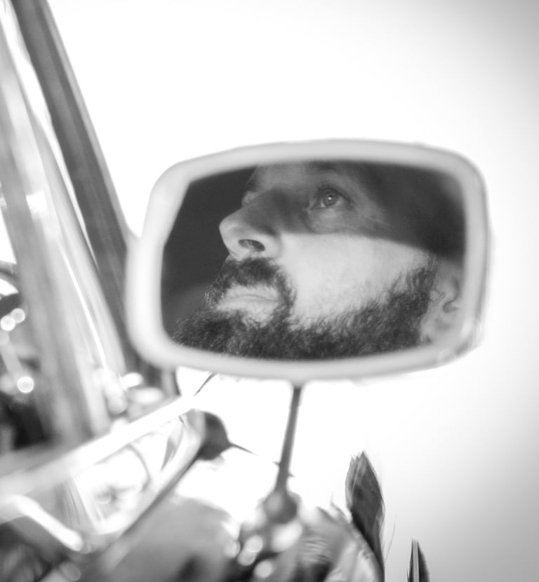 a man with a car and a car in a mirror