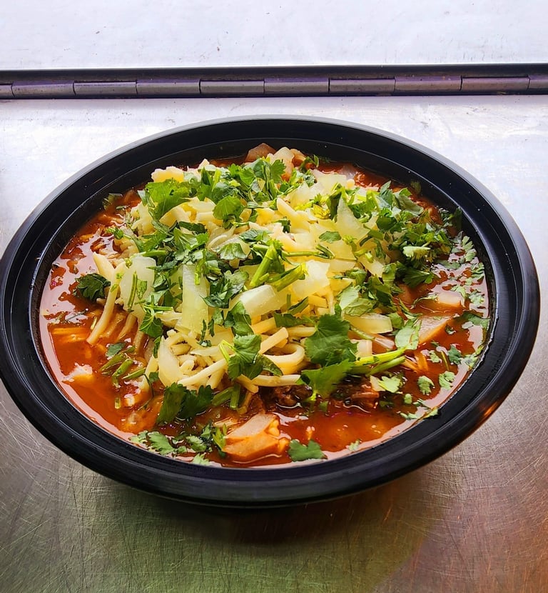 a bowl of soup with broccoli and cheese