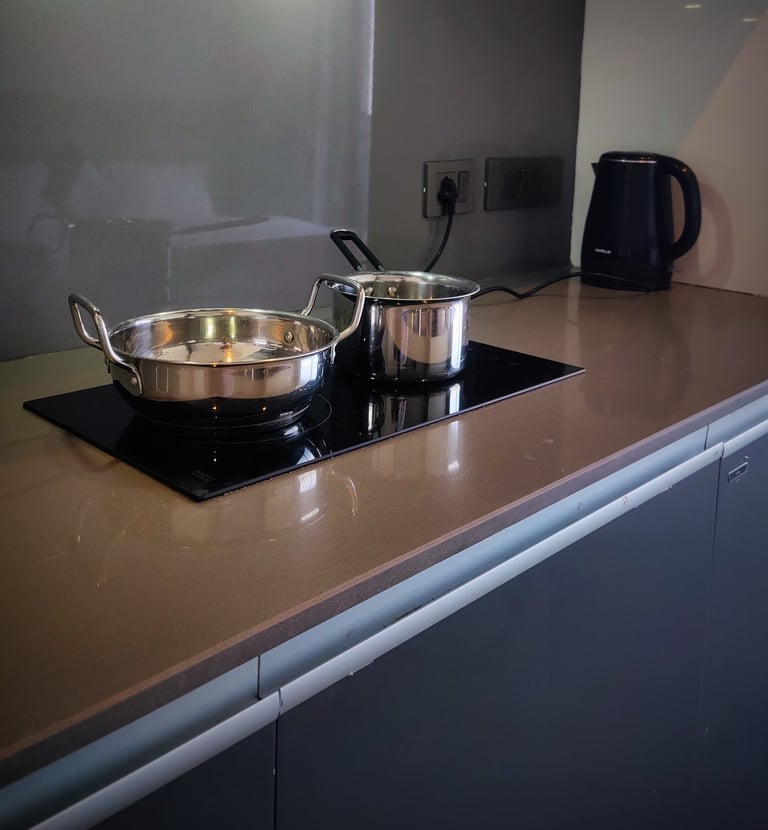 a stove top with pots and pans on a counter