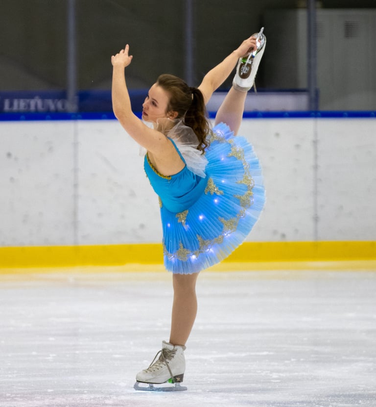 Adult figure skater performing element 5