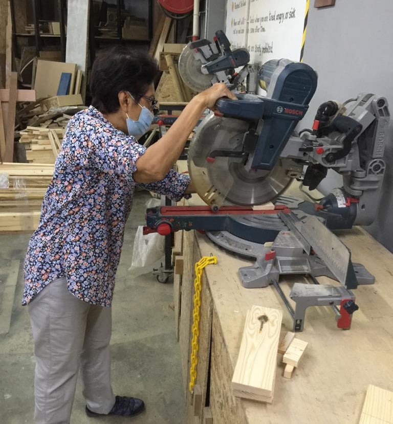 Lady managing a mitre saw