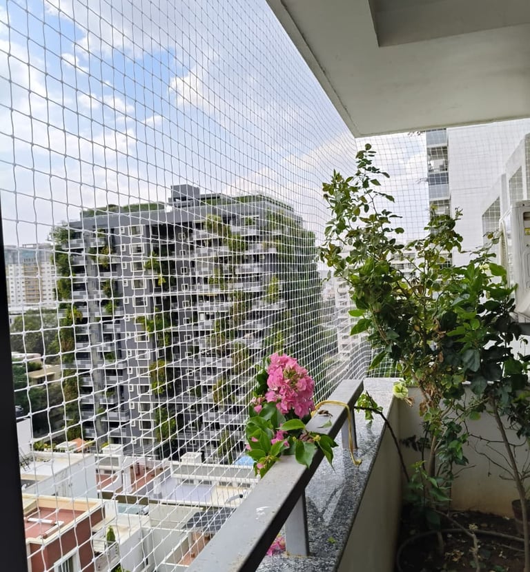 A happy child playing safely behind a well-installed balcony safety net.