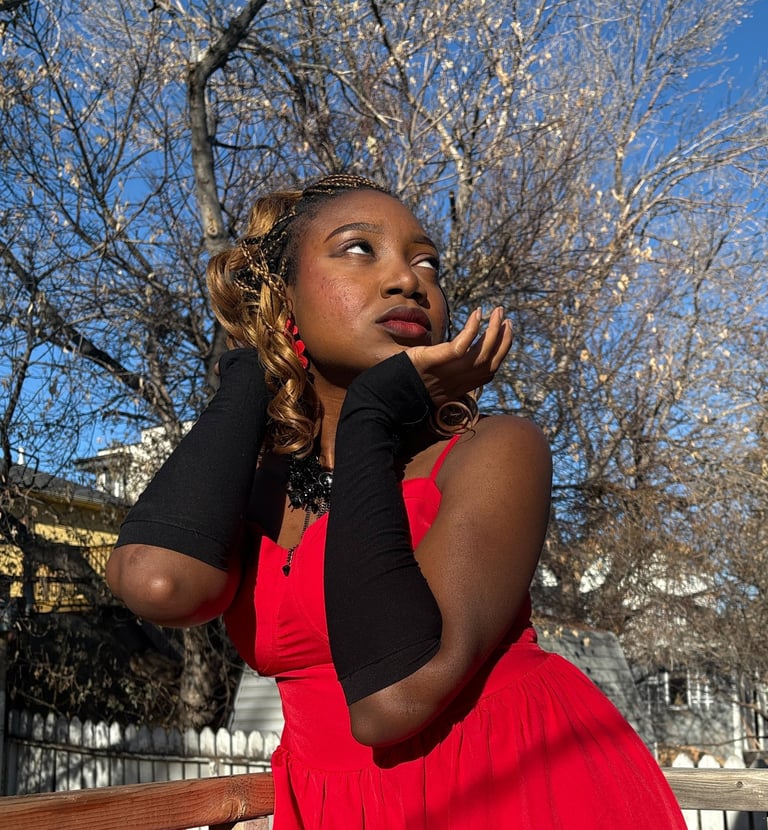 Iheoma Uzomba stylish pose in red gown and black gloves