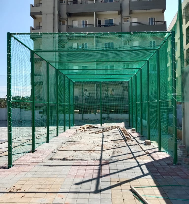 Wide shot of a football field surrounded by sturdy protective nets installed by Arjilli Enterprises.