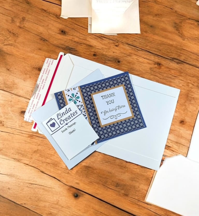 Thank You card, envelope and mailer on a table ready to be shipped.