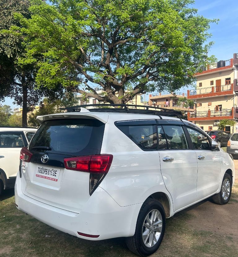 a white toyota venzard parked in a parking lot