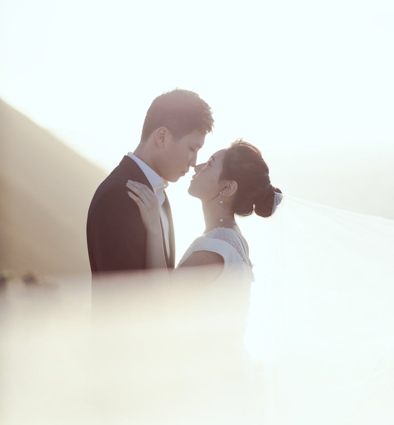 a bride and groom standing in front of a mountain