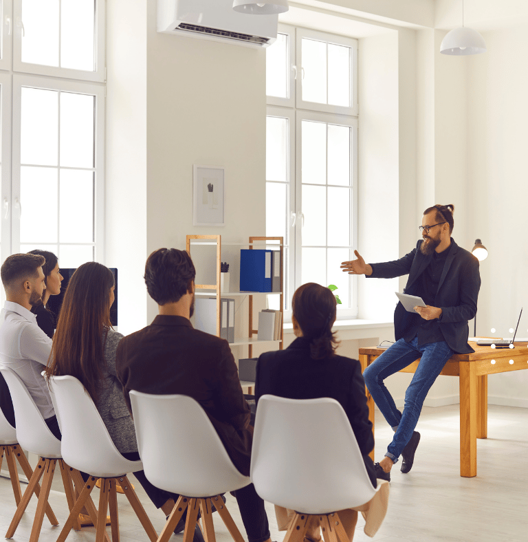 GLm LAW a man in a black shirt is standing in front of a group of people
