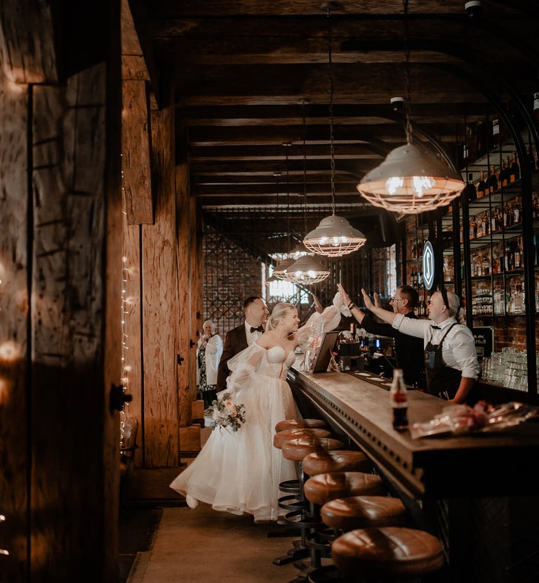 a bride and groomsmen are standing in a bar
