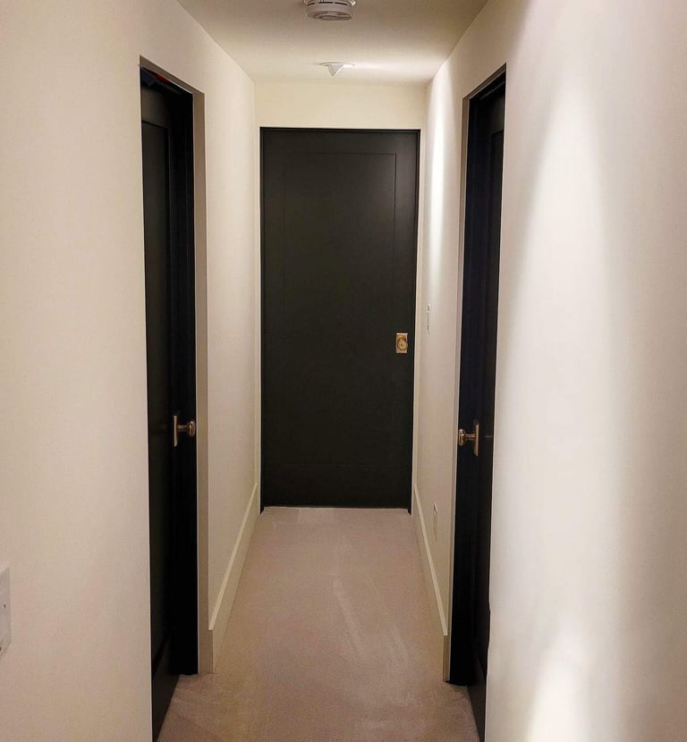 a hallway with a black door and a black door