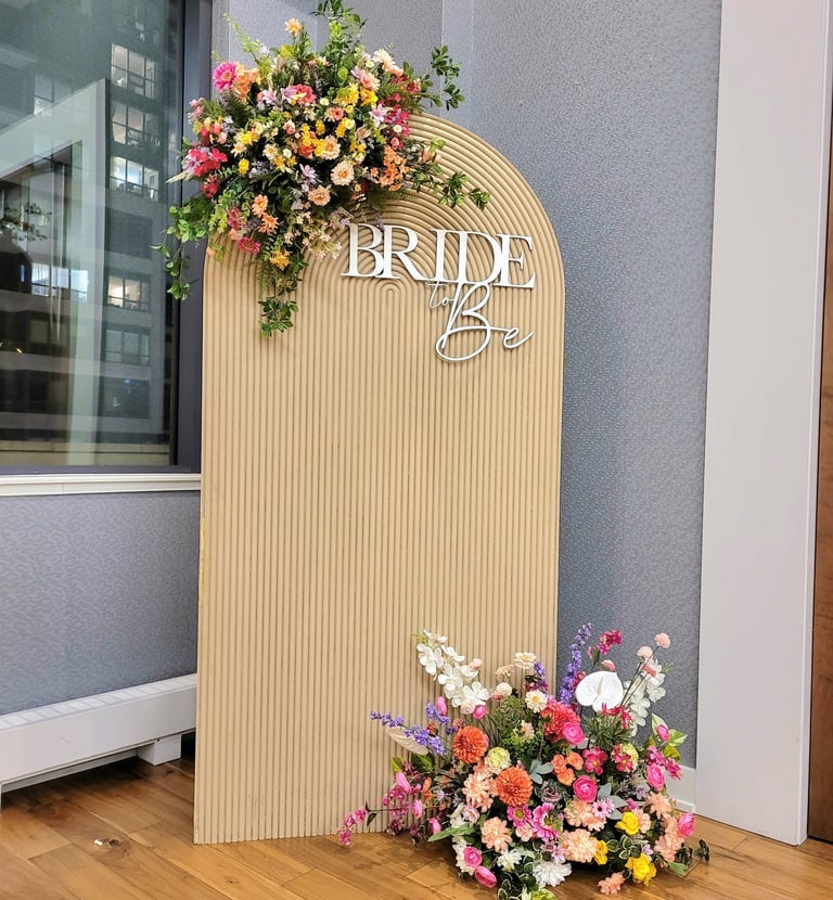bridal shower backdrop in beige with spring flowers