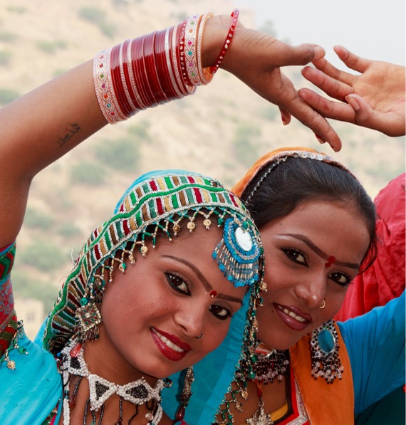 two women in colorful clothes and jewelry
