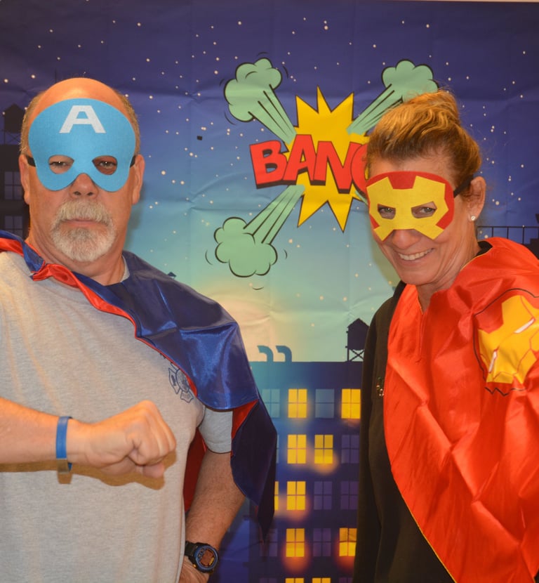 camp directors in their super hero outfits