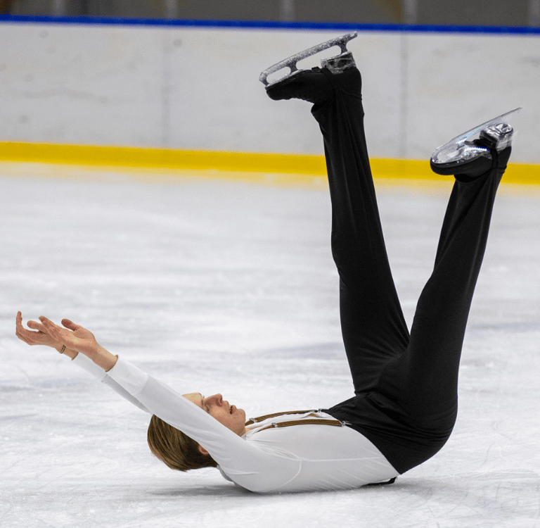 Adult figure skater performing element 6