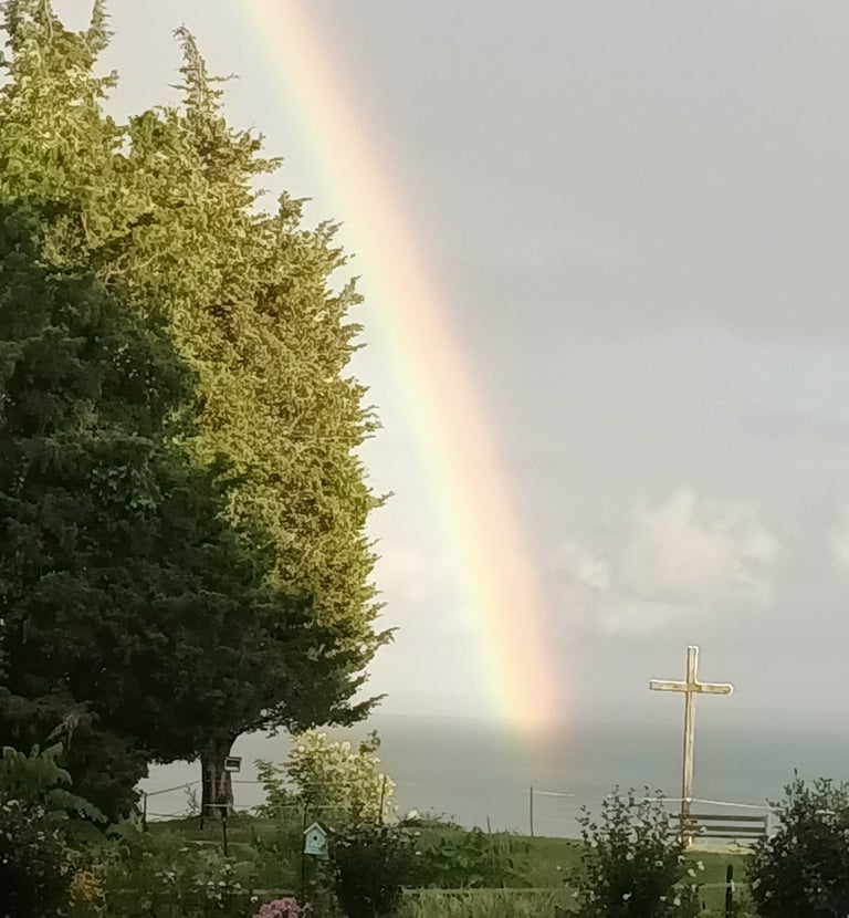 a rainbow and the cross at camp