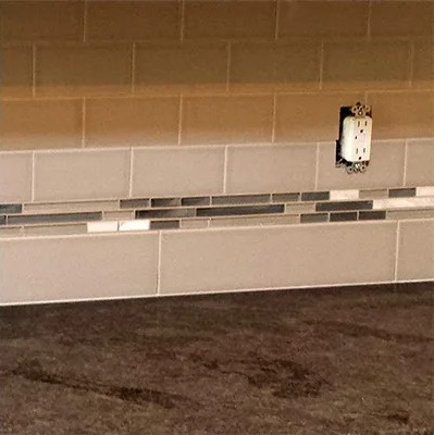 a kitchen counter top with a clock on the counter