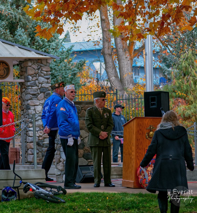 a man in a military uniform standing in front of a microphone