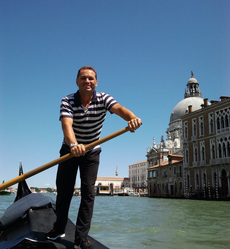 a man in a striped shirt is rowing a boat