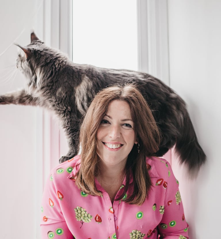 photo of gabi smiling at the camera with her maine coone cat 