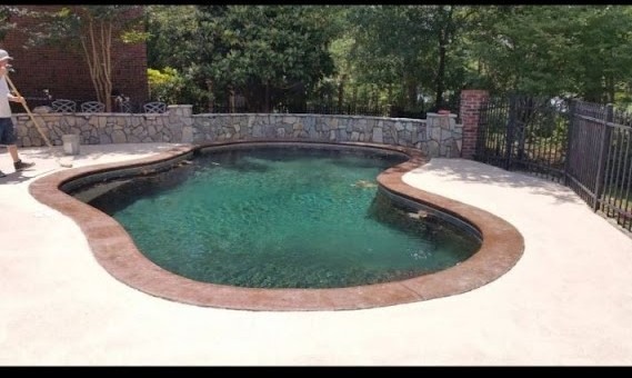 a man cleaning a pool with a mop