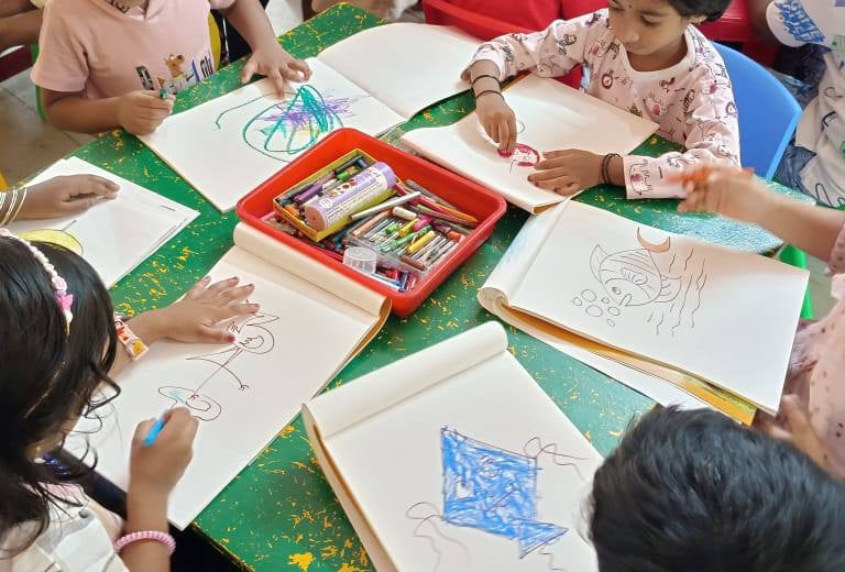 A group of preschoolers collaborating on a creative art project