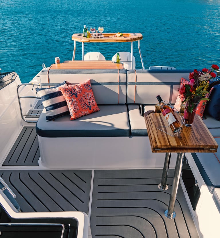 a boat with a table and chairs on the deck