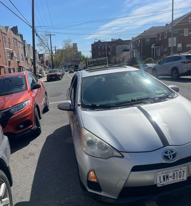 a car parked in a parking lot with a number plate