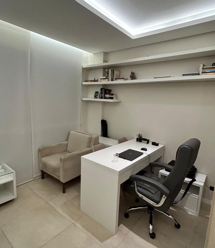 a desk with a chair and a chair in a room