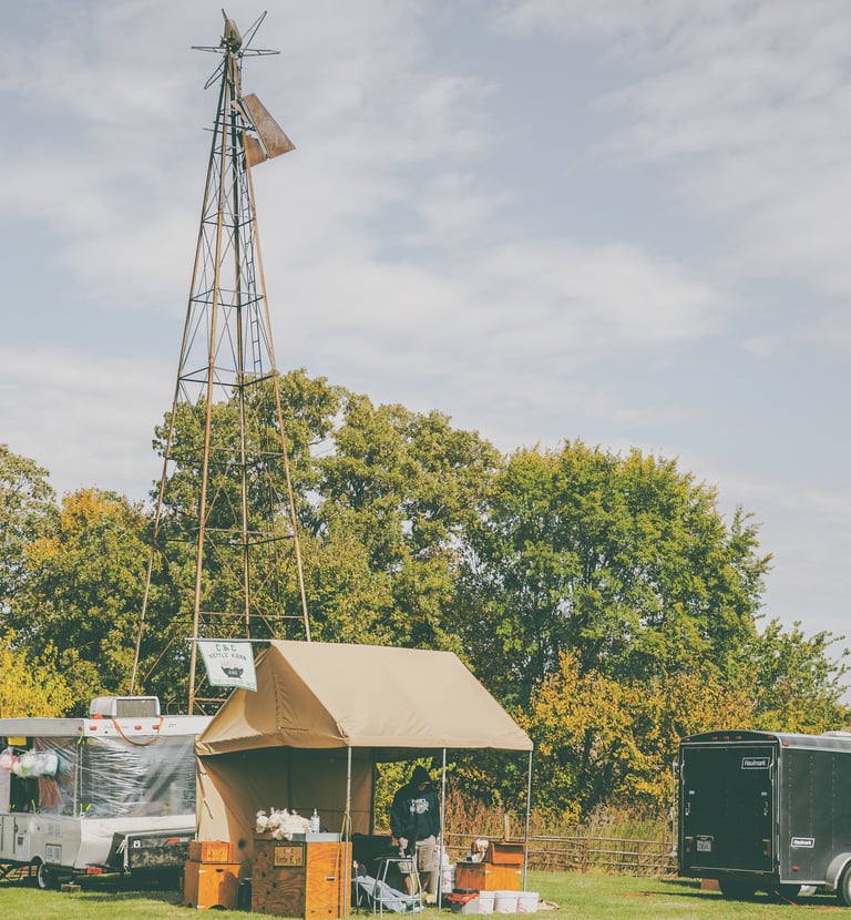 Man making kettle corn in front of a windmill