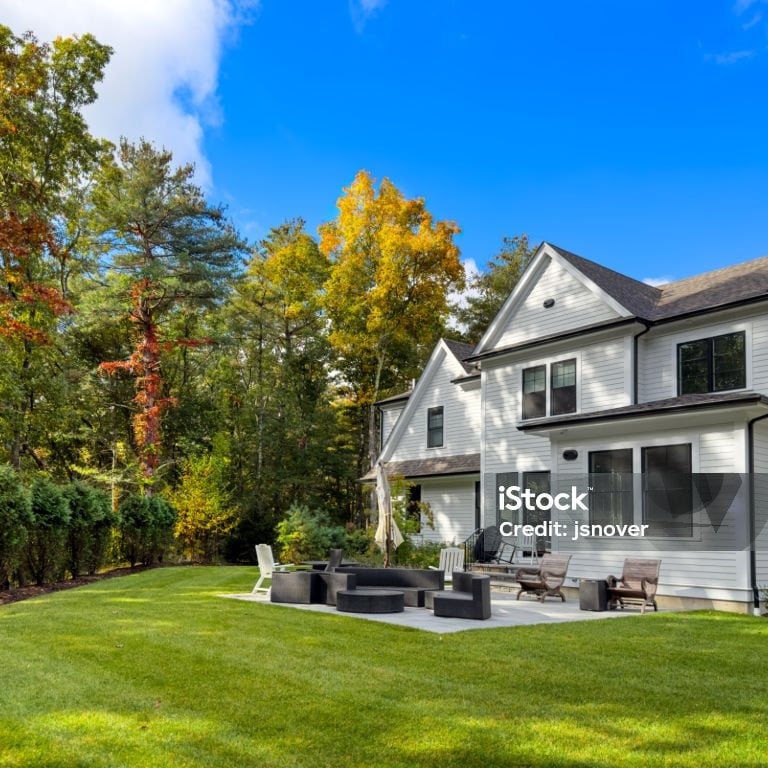 a large backyard with a fire pit and a patio